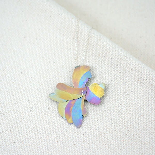 Her Glow at Golden Hour necklace, organic floral shaped pendant hand-painted titanium with yellow, blue, and pink stripes