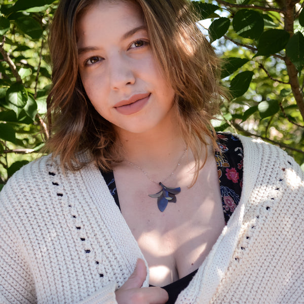 woman wearing the Her Soul Drips Purple Honey Necklace, a flower pendant, hand-painted purple, dark gold, and light pink