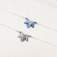 Load image into Gallery viewer, The two different colorful pattern options of the handcrafted Rise with the Sun bracelet, a delicate silver chain bracelet with a half sun-shaped hand-painted titanium charm in the middle.