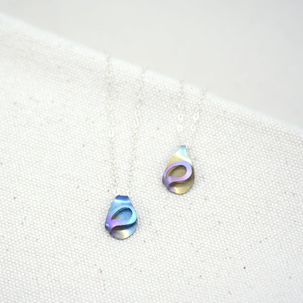 the two color options of The Rhythm of Rain hand painted teardrop necklace on a white background