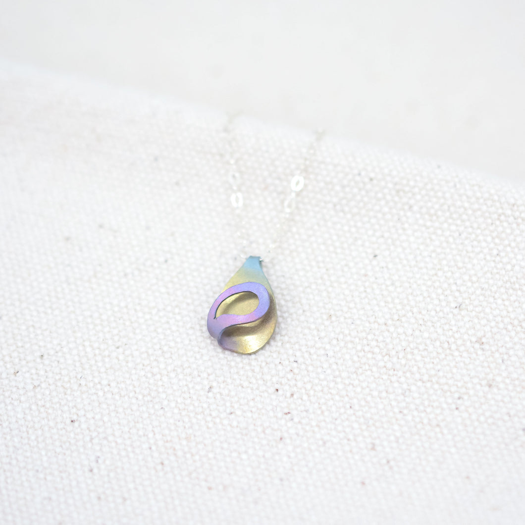 The Rhythm of Rain, a handcrafted teardrop necklace hand painted in gold and pink with hints of blue and purple