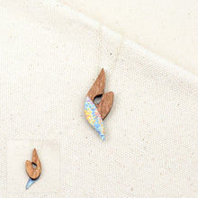 Load image into Gallery viewer, The Wind in Her Sails in dancing under the sunset sky, speckled pink, yellow, and blue