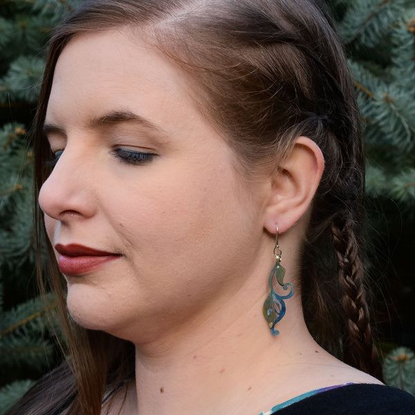woman modeling the Foliage She Leaves Behind Earrings silver blue-light yellow