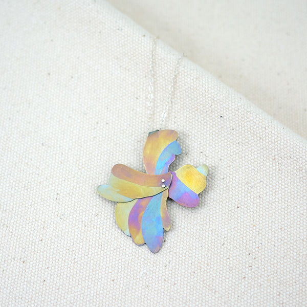 Her Glow at Golden Hour necklace, organic floral shaped pendant hand-painted titanium with yellow, blue, and pink stripes 
